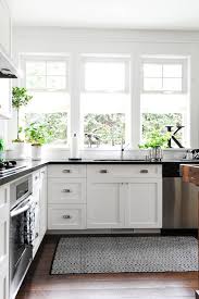 Black hardware will do just that. Black And White Kitchen Features White Shaker Cabinets Accented With Cup Pulls And Topped With Black Count Home Kitchens Craftsman Kitchen Kitchen Inspirations
