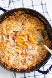 Dutch Oven Peach Cobbler Is An Easy And Versatile Crowd Pleaser Everyone Will Be Coming Back For Sec Dutch Oven Peach Cobbler Dutch Oven Cobbler Campfire Food