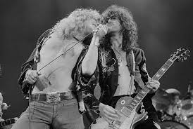 Robert Plant and Jimmy Page performing with British heavy rock group Led  Zeppelin, at Earl's Court, London, May 1975. Photo by Michael Putland.