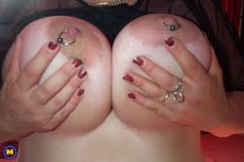 Dutch older amateur lady with huge natural pierced breasts sucking cock - a captivating scene