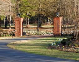 Rustic stone driveway columns punctuate the entrance to this great falls landscape. Brick Gate Pillars Google Search Brick Columns Landscape Lighting Brick Fence