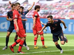 Lewandowski was visibly emotional as he sunk to the ground in celebration. Bayern Munich Striker Robert Lewandowski Wheels Away In