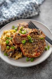 Air fryer pork chops coming in hot and fast with the flavors of italian porchetta: Air Fryer Herb Crusted Pork Chops Garnished Plate