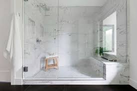 This welcoming all white shower uses marble and chrome fixtures to bring about modern design. Marble Walk In Shower With Large Marble Grid Floor Tiles Modern Bathroom
