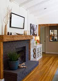 The wooden painted sign is a nice touch that adds some contrast to the light color theme along with just a touch of green and yellow. Bold Black Paint Can Turn Even The Most Basic Builder Grade Closet Doors Into Architectural Stat Home Fireplace Painted Brick Fireplaces Black Brick Fireplace