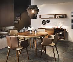 If you prefer the feel of an informal eating arrangement, consider a round dining room set. Round Wood And Leather Dining Table Wharfside Luxury Furniture