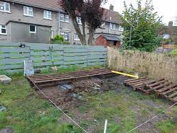 I wanted something in my garden to sit my pallet bench on. Pallet Deck With Fire Pit Hometalk