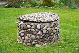 This fiberglass rock well cover looks like granite. 17 Outdoor Well Cover Ideas With Photos Upgraded Home