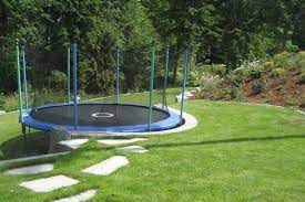 The trampoline frame is not sunk into the ground. Trampoline On Sloped Ground How To Set Up Gettrampoline Com