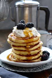 Delicious pancake toppings including fresh berries, maple syrup, whipped cream, and chocolate chips for the ultimate pancake recipe experience