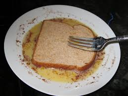 Two pieces of french toast with egg and sausage in the middle and there's french toast sandwich. French Toast Pantry Chef