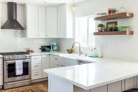 Retro White Shaker Kitchen With Black And Stainless Appliances Floating Shelves Mid Century Modern Ligh Kitchen Redesign White Shaker Kitchen Kitchen Remodel