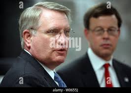John P. Walters, director of the Office of National Drug Control Policy,  right, listens to Maj. Vincent Moore, left, of the Atlanta Police  Department, after walking the streets of a drug infested