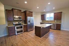 Similarly, should hardwood floors match cabinets? Contemporary Craftsman Espresso Cabinets With White Porcelain Top Large Kitchen Island On Oak Wood Flo Interior Design Kitchen Wood Floor Kitchen Dark Cabinets