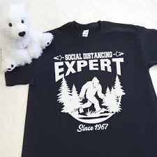 Available in a range of colours and styles for men, women, and everyone. Social Distancing Expert Bigfoot Shirt In All Sizes Puddle Bear