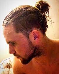 New Man Bun Hairstyle Trend The Low Undercut Man Bun Hairstyle Within Undercut Hairstyle With Man Bu Man Bun Hairstyles Man Bun Haircut Long Hair Styles Men