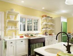 Dramatic black accents, such as the countertops; Home Living Blog Green And Yellow Kitchen