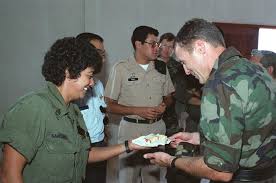 Colonel Russ Zajtchuk, a surgeon with the 41st Combat Support Hospital,  receives a piece of graduation