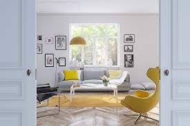 This living room features a beautiful dark wood floor complemented by a white and gray rug in a moroccan pattern. Beautiful Living Room Yellow And White Living Room