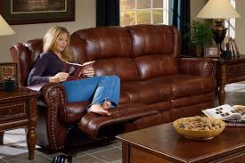 Armrests with storage and cup holders keep. Buckingham Chestnut Leather Dual Reclining Sofa By Catnapper 4111 C