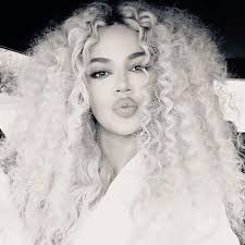 Tracee had her curly hair down, and donned a bright shade of lipstick to match her manicure. Khloe Kardashian Rock Diana Ross Inspired Curly Wig