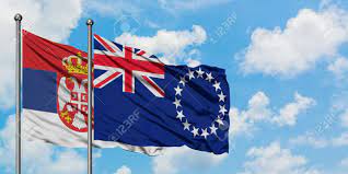 The flag of the cook islands, officially known as the cook islands ensign, is based on the traditional design for former british colonies in the pacific . Serbia And Cook Islands Flag Waving In The Wind Against White Cloudy Blue Sky Together Diplomacy Concept International Relations Stock Photo Picture And Royalty Free Image Image 147481159