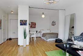 Loft apartment with living room bedroom combo behind frosted glass sliding doors and wood barn doors. Living Room Bedroom Combo See More