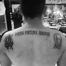 On john wick's shoulders, he tattooed fortes fortuna aduivat which is a latin phrase and the meaning of this phrase is that it is only the strong ones that fortuna (the goddess) comes to save. John Wick Tattoo Fortis Fortuna Shefalitayal