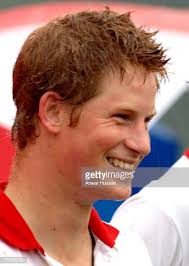 Prince Harry smiles in the rain at Cirencester Park Polo Club
