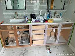 White bathroom cabinet doors and drawer fronts. How To Update An Old Vanity With New Drawers Doors And Paint Southern Hospitality