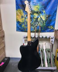 We're bringing you a sleek HH Jazzmaster in Closet Classic Black from Andy  Hicks. This beauty is fully blacked out with Cult Leader humbuckers, black  anodized guard and matching headstock. It's headed