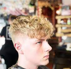 An afro is a celebration of curly hair, and allowing it to grow free and fluffy ensures that the hair is nice and healthy. Blonde Curly Undercut Blonde Hair Boy Curly Hair Men Curly Undercut