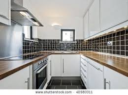 Floor is an interdeterminate colour which will go with anything. Modern Kitchen With Black Ceramic Tiles And Wooden Worktop Modern Black Kitchen White Contemporary Kitchen Modern Kitchen
