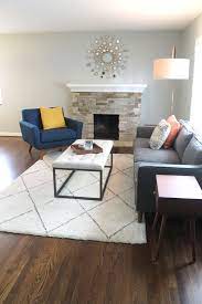Midcentury Modern Living Room With Blue Gray Walls Grey Couch Blue Chair Brass Lighting A Modern Grey Living Room Couches Living Room Grey Couch Living Room