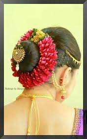 South Indian Bride Flower Wrapped Bun With Embellishment Jewelry Beautiful Wedding Hair Indian Bridal Hairstyles Bridal Hairdo