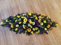A classic posy tribute in yellow and white shades. Purple Yellow White Double Ended Casket Spray The Flower Fountain