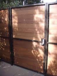Gravity allows the weight of the gate to be distributed inward down the length of the 2 x 4 to the bottom hinge and into the post, instead of pulling directly downward and placing too much stress on the hinges. Steel Frame Horizontal Slats Wooden Gates Driveway Fence Design Wood And Metal Fence