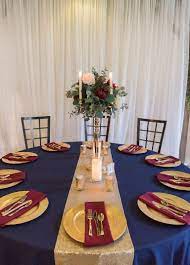 Rustic Wedding Reception Decor Round Tables With Navy Blue Tablecloths Gold Ch Navy And Burgundy Wedding Navy Wedding Decorations Wedding Floral Centerpieces
