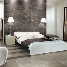 Create a focal point or feature wall in any room with wall tiles arranged in interesting patterns or color. Dark Silver Marble Effect Tiles Have Been Used On The Wall Of This Modern Bedroom And Look Great Marble Effect Til Bedroom Tile Modern Bedroom Bedroom Wall
