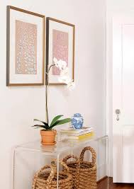 Seagrass Baskets Tucked Under Clear Acrylic Console Table Transitional Entrance Foyer Console Table Decorating Acrylic Side Table Console Table Styling