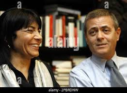Italian daily La Repubblica Editor in chief Ezio Mauro, right, and the wife  of Daniele Mastrogiacomo, Luisella Maria Longo Orhiuela, talk to  journalists in the newspaper headquarters, in Rome, Monday, March 19,