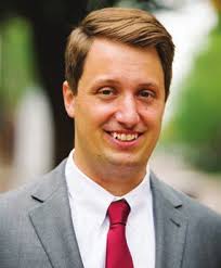 WMU's President, Dr. Edward Montgomery, driving the Bronco Baja vehicle in  front of The College of Engineering and Applied Sc