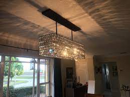 Lit from within, it sparkles in a room, with each glass crystal refracting the light for a prismatic display. Pottery Barn Adeline Rectangle Chandelier Rectangle Chandelier Dining Room Dining Room Decor Interior Design Tips