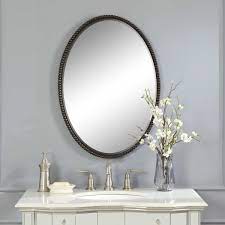 A unique pivoting design allows for easy adjustment of the angle to ensure optimal viewing. Sherise Bronze Oval Mirror Uttermost