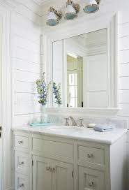 Gorgeous White Beach Style Bathroom Is Fitted With Industrial Wall Sconces Mounted To A Whi Bathroom Design Decor Beach House Bathroom Bathroom Remodel Designs