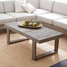 This piece is crafted from solid poplar wood and oak and birch veneers, and it features rounded pilasters with turned details that contribute to its traditional feel. Portside Outdoor Coffee Table