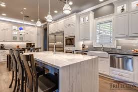 This kitchen offers an elegant vibe with its walnut finish cabinetry, flooring, and seats. Custom Kitchen Island Ideas Custom Island Installation In Houston