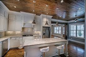 Rustic Kitchen With White Cabinets Snowfall Granite Counter And Breakfast Bar Isl White Kitchen Rustic Minimalist Kitchen Design Replacing Kitchen Countertops