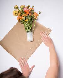 A bouquet of vivid golden, auburn, chartreuse, and rouge blooms accented with textural foliage and berries comes expertly arranged in a dark stained hand crafted wood box. How To Wrap Fresh Flowers A Genius Freshness Trick So They Don T Wilt