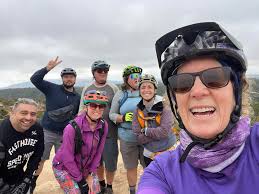 Beginner group having a fun ride and checking out the huge masticator  clearing vegetation along fire roads for fire management.